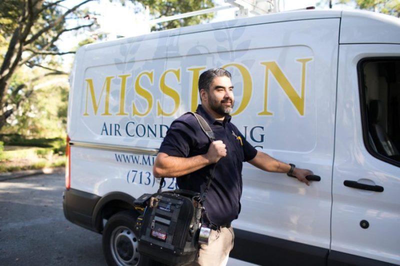 mission ac repair technician opening up company van after performing repairs