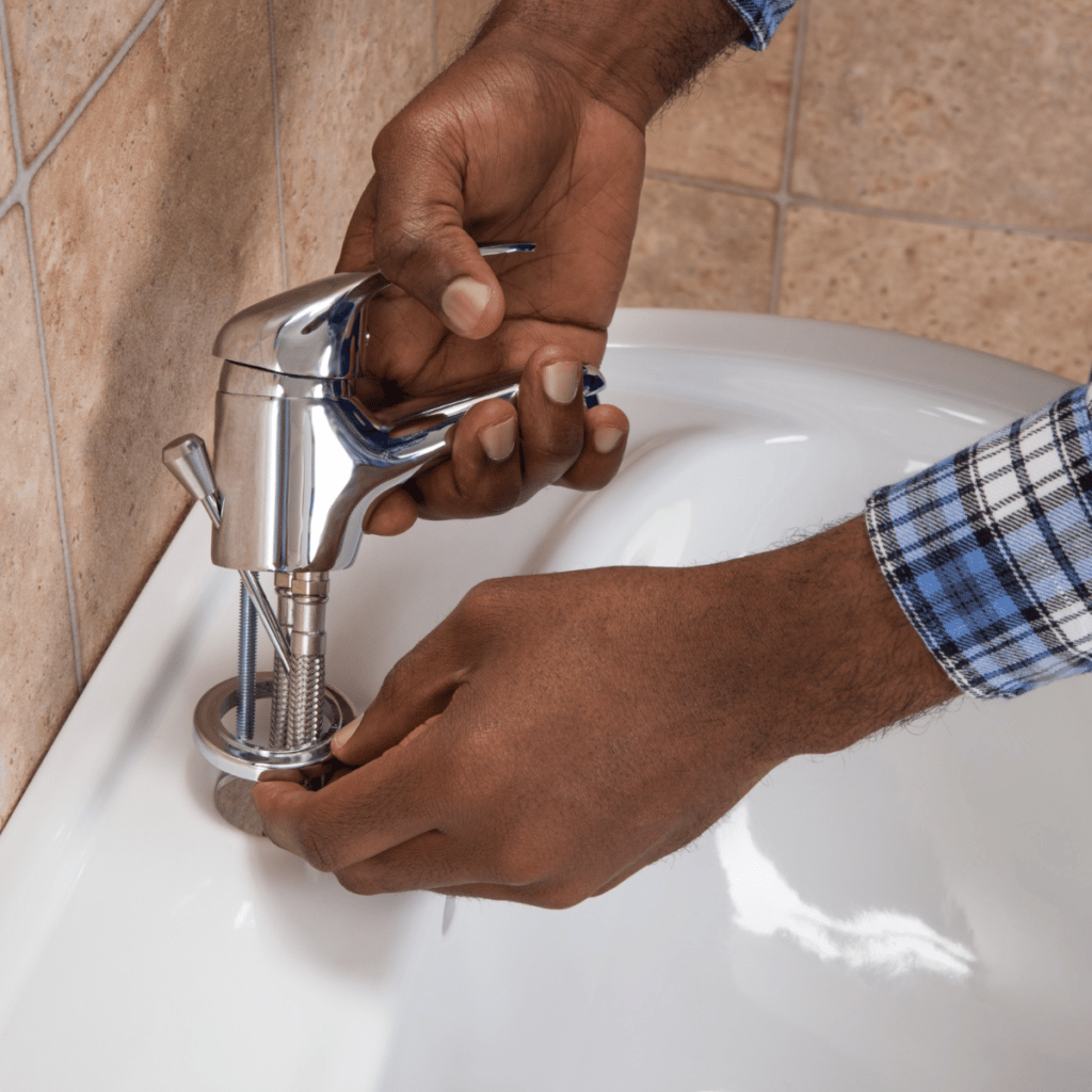 plumber installing a new faucet