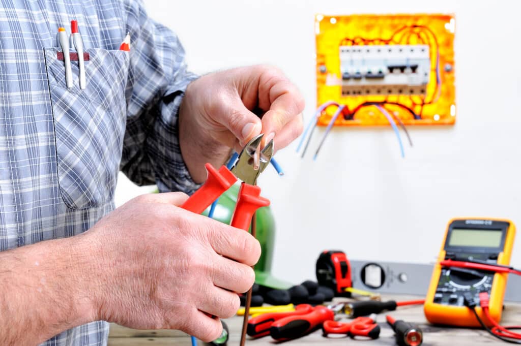 Electrician cutting a cable during a rewiring job