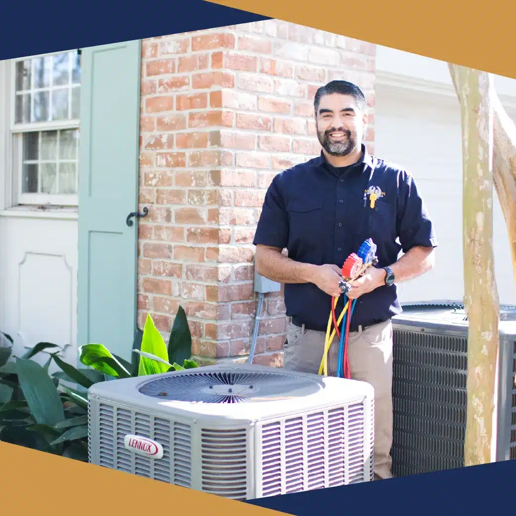 HVAC technician smiling beside a Lennox outdoor unit while holding refrigerant hoses