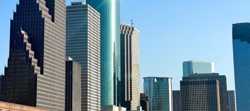 Downtown Houston skyline featuring modern high-rise office buildings under a clear blue sky
