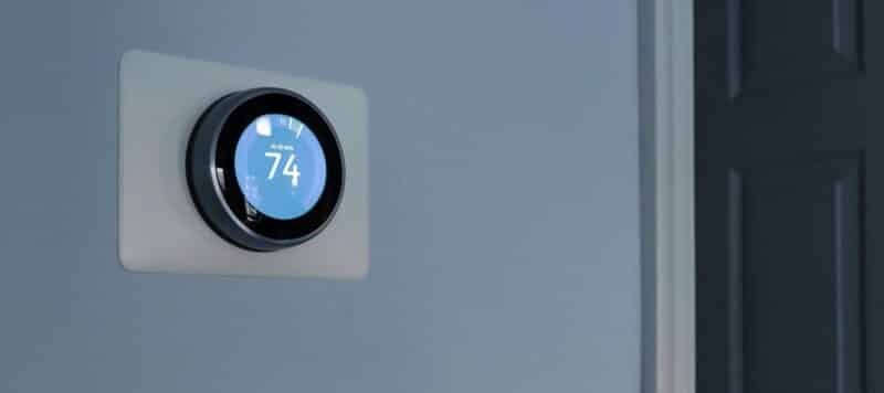 Smart thermostat displaying temperature settings